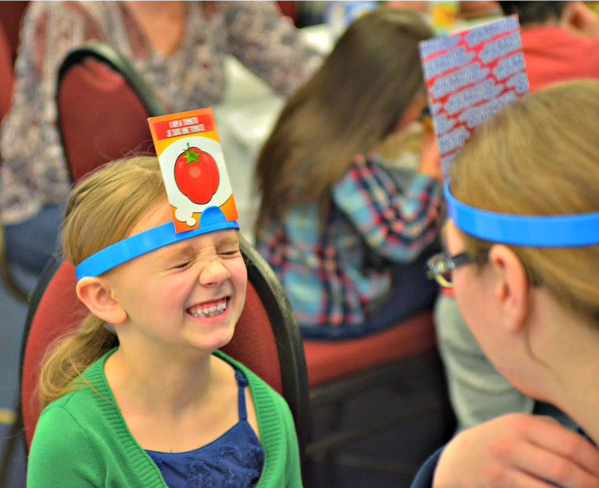 A young girl playing a game with her mom.