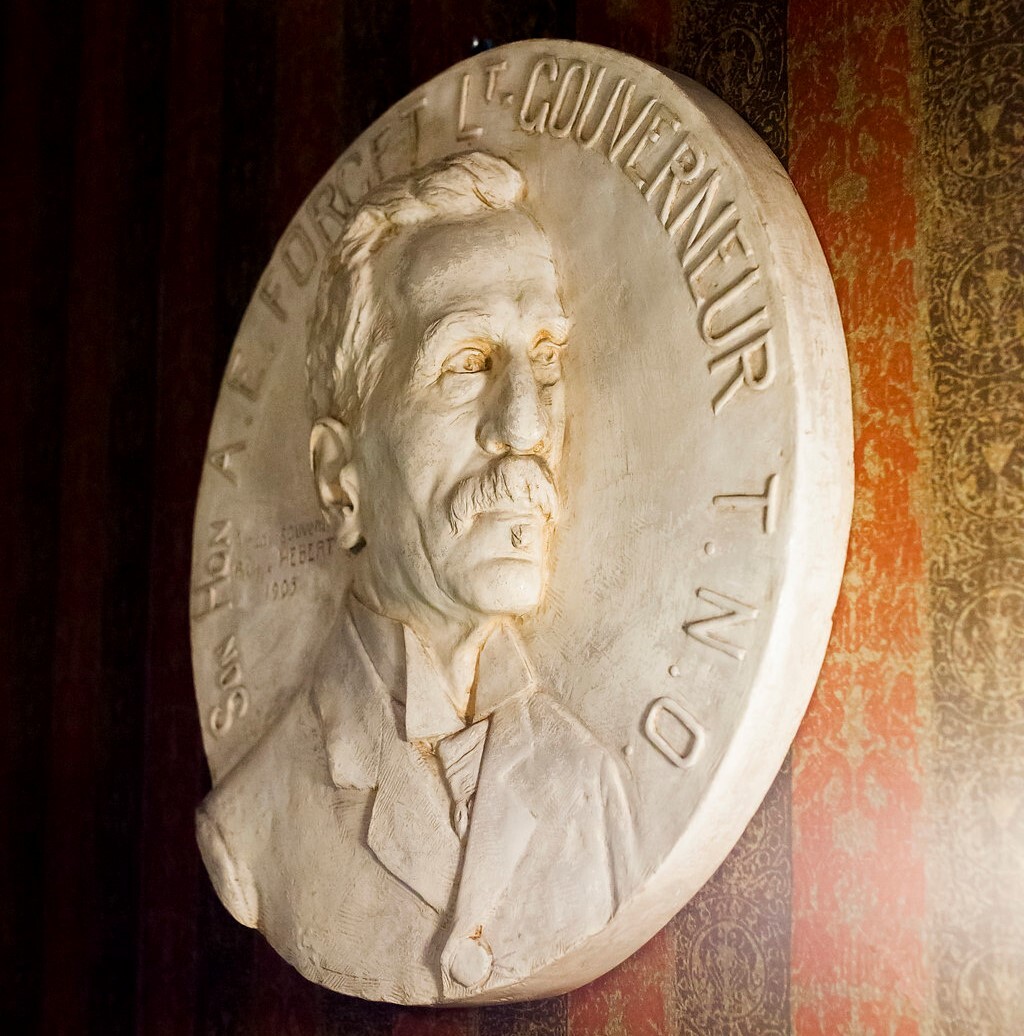 A white medallion of A. E. Forget, the first Lieutenant Governor of Saskatchewan which hangs in the ceremonial entrance of the museum in Government House SK