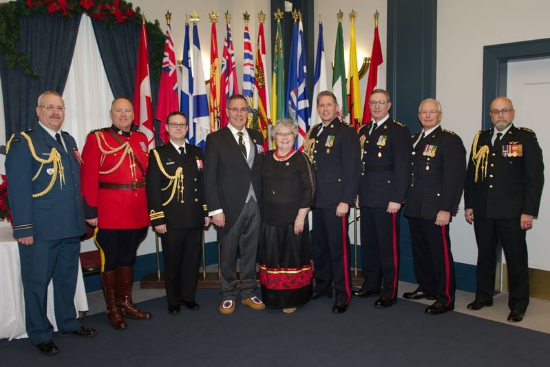 The Lieutenant Governor of Saskatchewan and his wife standing with men in military and RCMP uniforms at the New Years Day Levee 2020