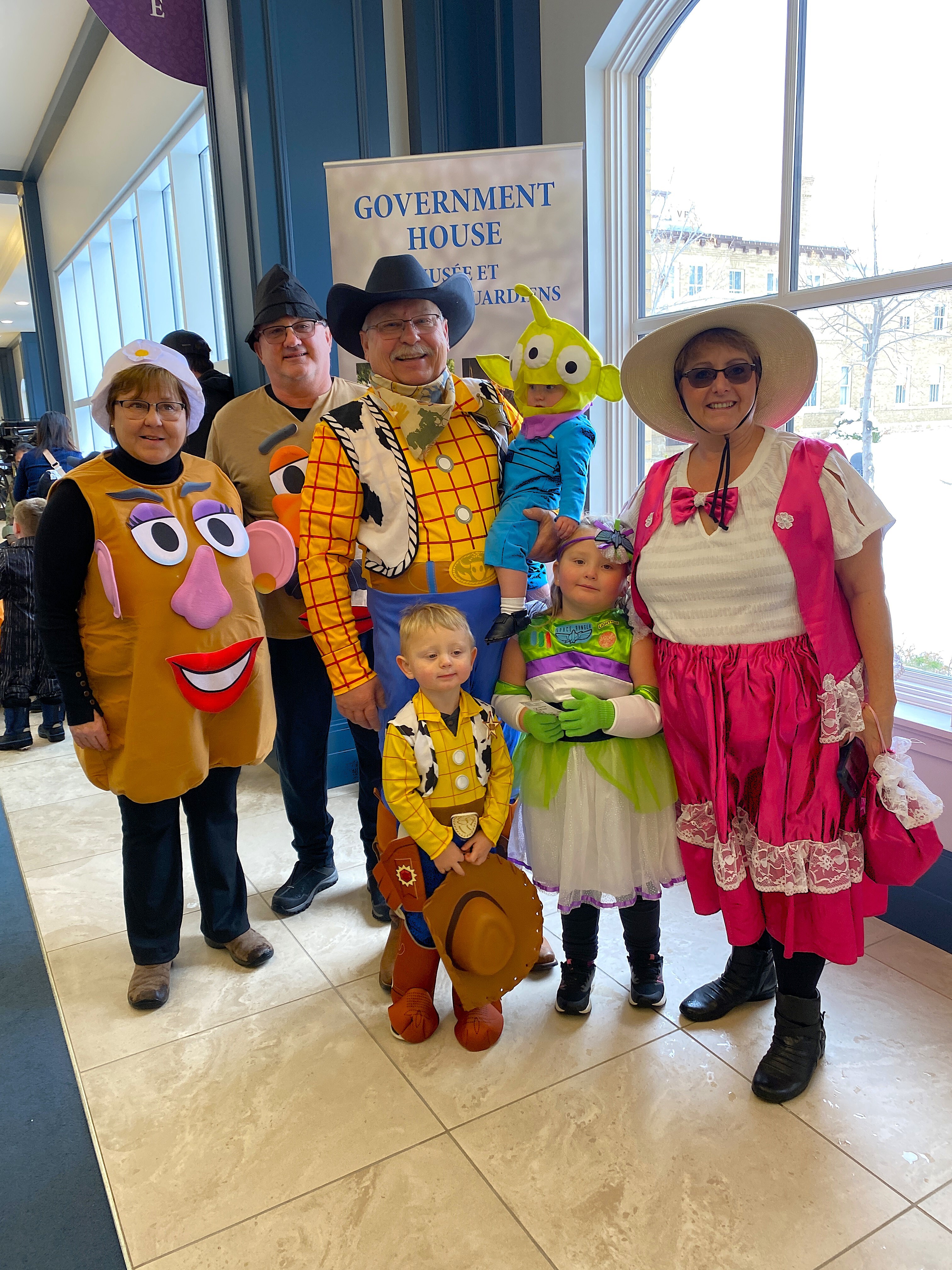 A multi-generational family dressed in costumes from the Toy Story Movie.