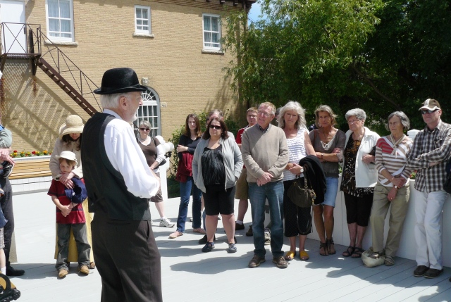Vincent Murphy as George Watt speaking with tour group