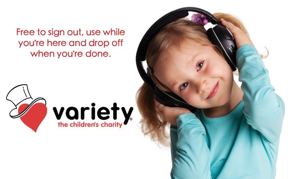 A picture of a little girl wear sound blocking ear muffs and Variety Sask logo