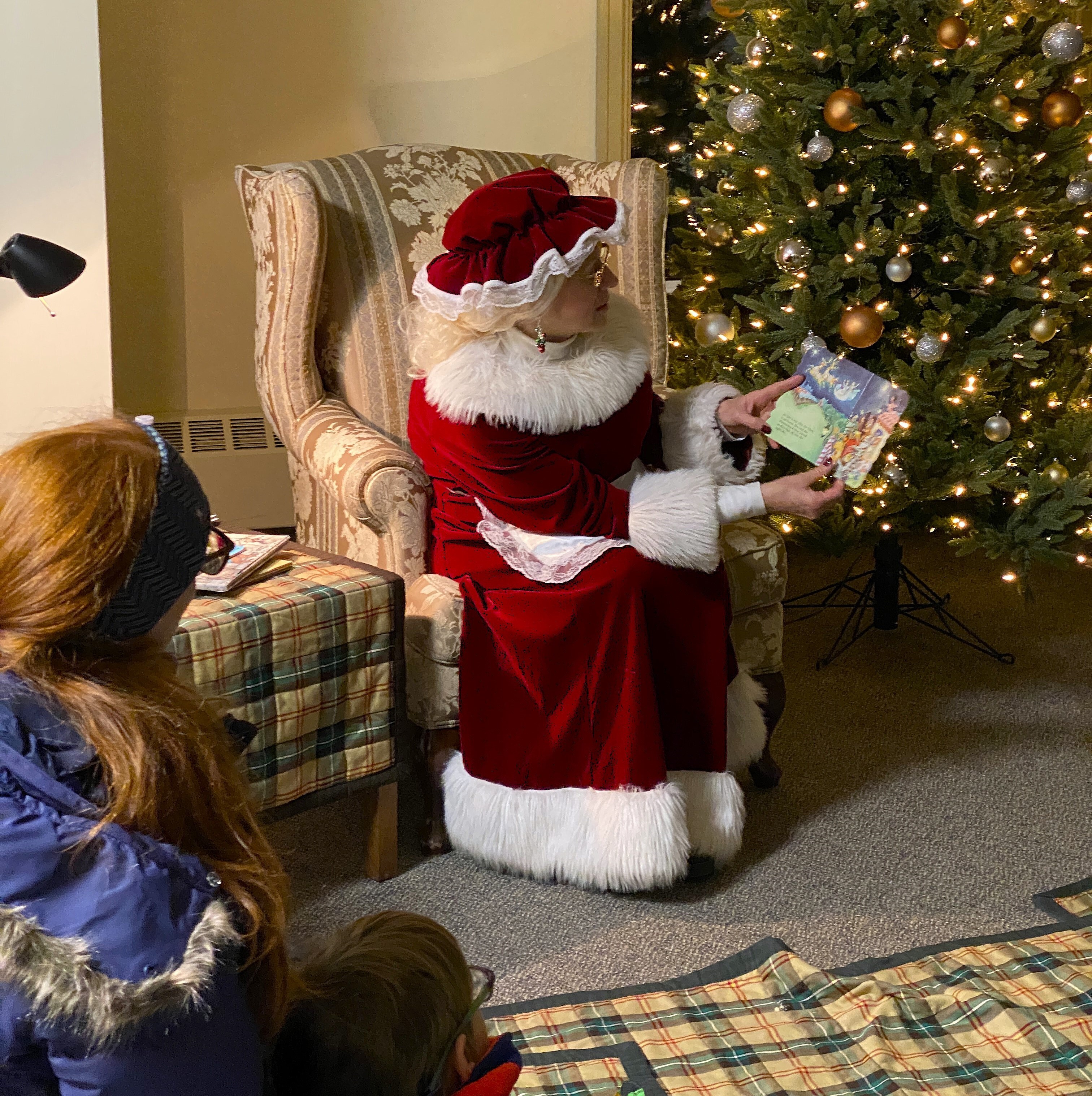 Mrs. Claus reading Christmas stories to visitors of Government House Saskatchewan.