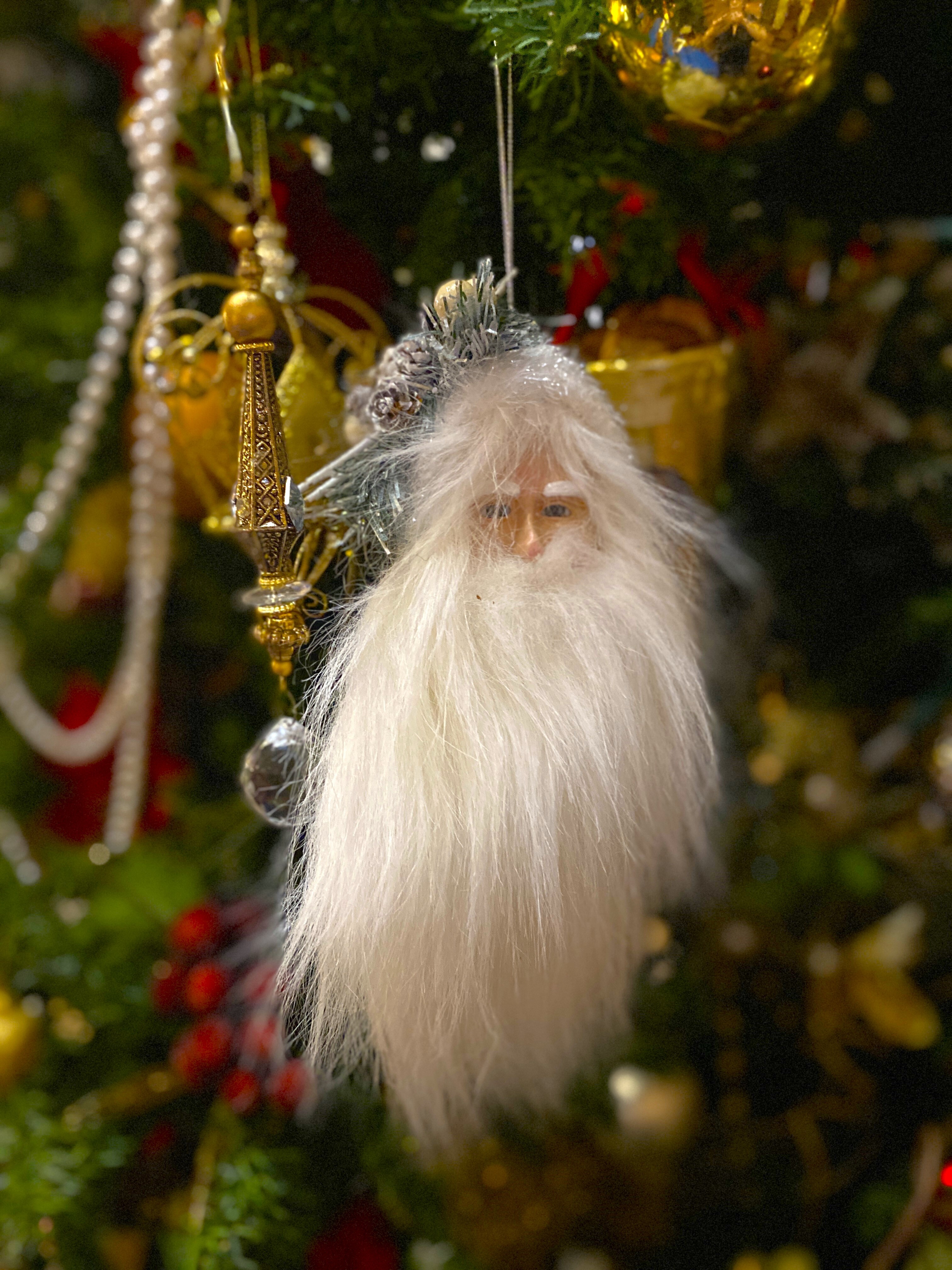 A santa and other decorations hanging from a Christmas tree in the Government House Saskatchewan museum.